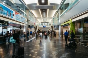 Travellers walking through an airport concourse