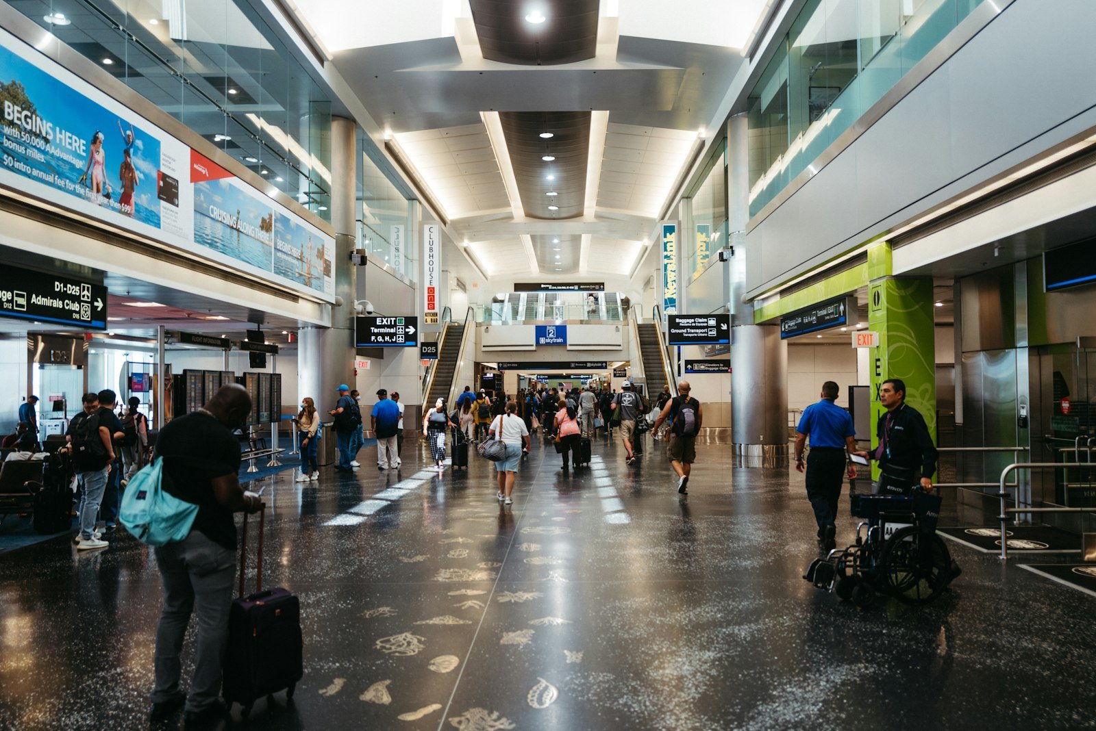 Travellers walking through an airport concourse