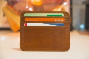 Wallet with cash and cards on a dark surface