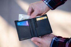 Bifold wallet held open in one hand